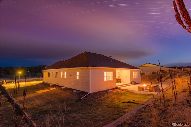 5693 Missoula Trl, Castle Rock, CO 80108 - back of property at dusk featuring a patio area and roof with shingles