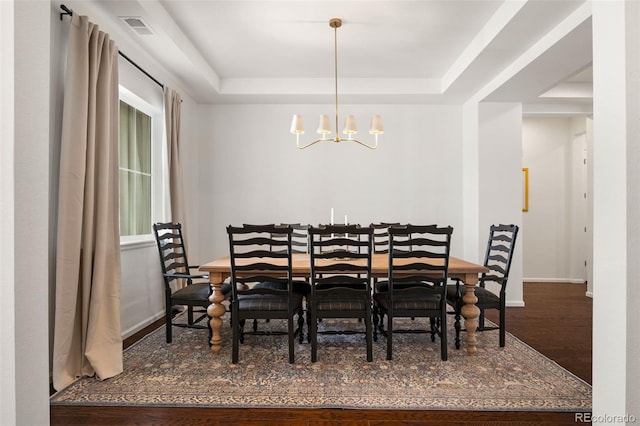 5693 Missoula Trl, Castle Rock, CO 80108 - dining space featuring a tray ceiling, a chandelier, and wood finished floors