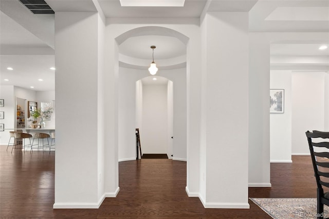 5693 Missoula Trl, Castle Rock, CO 80108 - hall featuring arched walkways, a tray ceiling, dark wood-type flooring, and recessed lighting