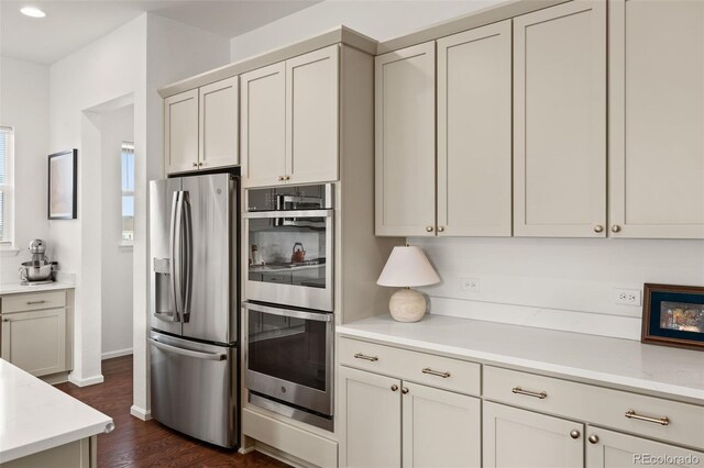 5693 Missoula Trl, Castle Rock, CO 80108 - kitchen featuring stainless steel appliances, dark wood-type flooring, recessed lighting, and light stone countertops