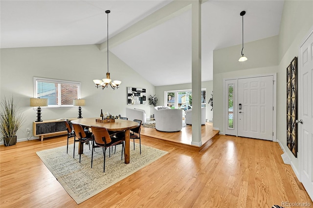 dining area with high vaulted ceiling, light wood-type flooring, beamed ceiling, a chandelier, and radiator