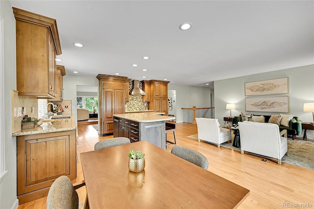 dining room with recessed lighting and light wood-type flooring