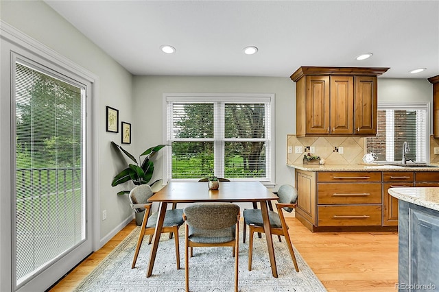 dining room with light wood-style flooring and recessed lighting
