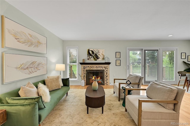 living room with healthy amount of natural light, wood finished floors, a fireplace, and recessed lighting