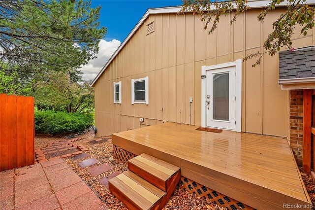 back of house featuring a wooden deck and board and batten siding