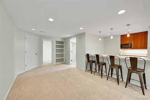 kitchen featuring black microwave, light carpet, baseboards, built in features, and recessed lighting