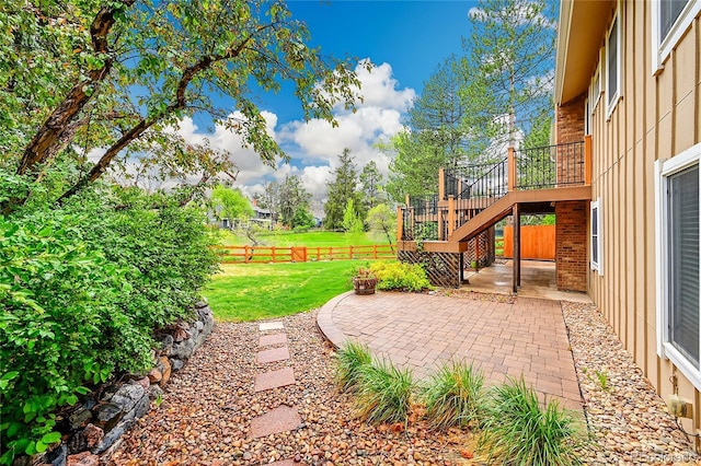 view of yard featuring a patio and stairs