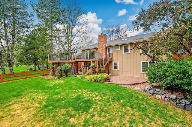 rear view of house featuring board and batten siding, stairway, a deck, a patio area, and a chimney