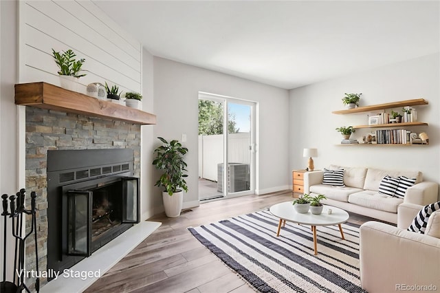 1707 Ostia Cir Unit 46, Lafayette, CO 80026 - living room with light wood finished floors and a stone fireplace