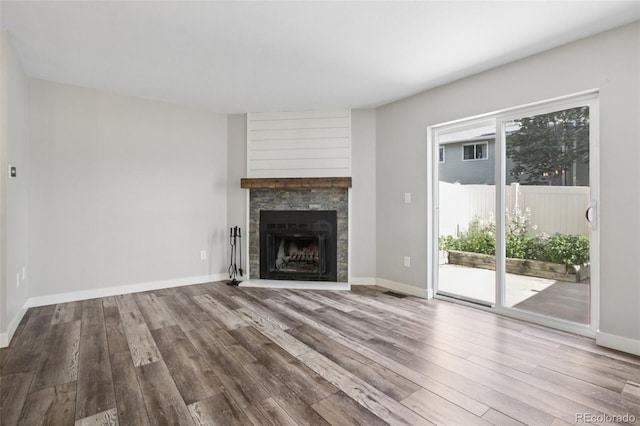1707 Ostia Cir Unit 46, Lafayette, CO 80026 - unfurnished living room featuring wood finished floors and a stone fireplace