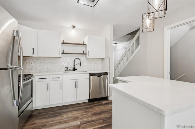 1707 Ostia Cir Unit 46, Lafayette, CO 80026 - kitchen with stainless steel appliances, open shelves, decorative backsplash, white cabinets, and dark wood finished floors