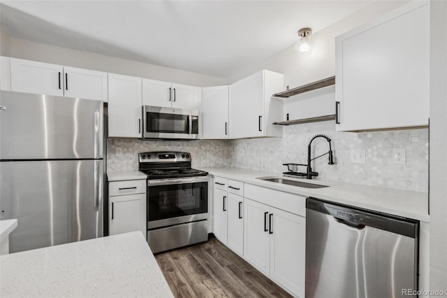 1707 Ostia Cir Unit 46, Lafayette, CO 80026 - kitchen featuring appliances with stainless steel finishes, open shelves, white cabinetry, and dark wood-style floors