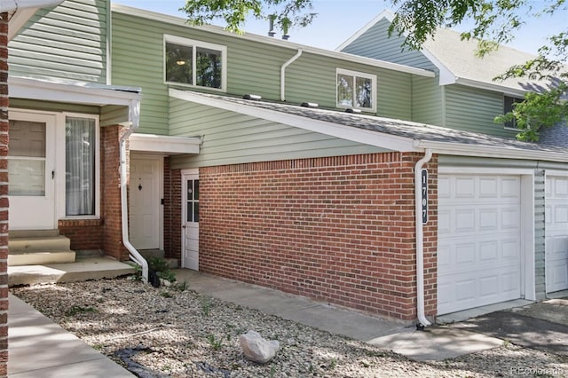 1707 Ostia Cir Unit 46, Lafayette, CO 80026 - view of front of property with brick siding, a garage, and entry steps