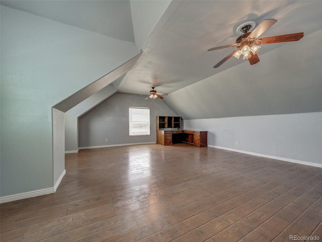 additional living space with dark wood-type flooring, ceiling fan, and vaulted ceiling