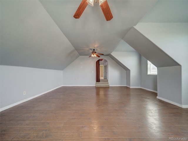 additional living space featuring lofted ceiling, dark wood-type flooring, and ceiling fan