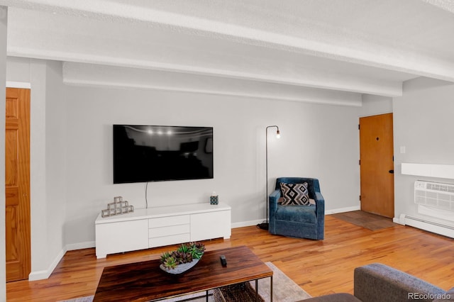 living area with a wall unit AC, baseboards, beam ceiling, light wood-type flooring, and baseboard heating