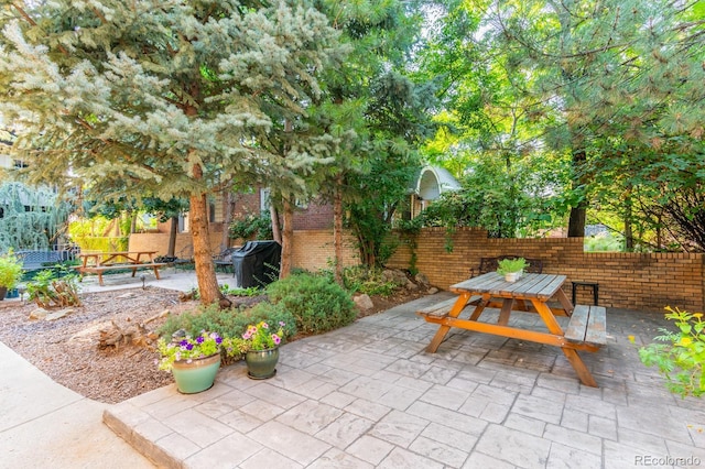 view of patio featuring outdoor dining space and fence