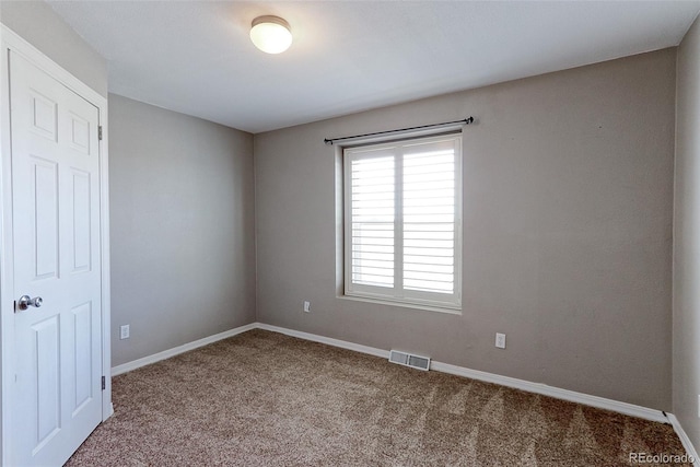 empty room featuring light carpet