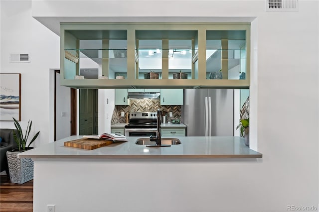 kitchen featuring tasteful backsplash, visible vents, a sink, and appliances with stainless steel finishes