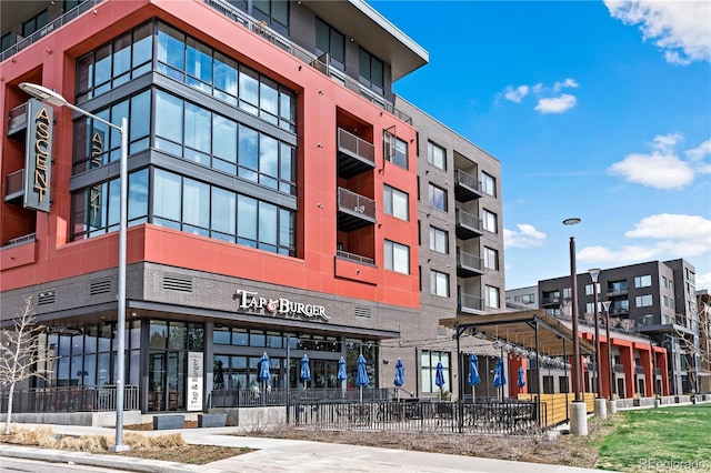 view of building exterior with fence