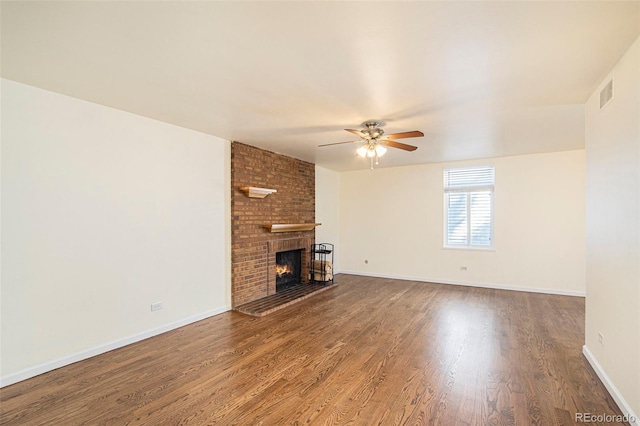 unfurnished living room featuring ceiling fan, a fireplace, and wood-type flooring