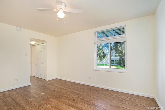 spare room featuring ceiling fan and hardwood / wood-style flooring