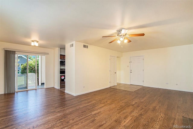 empty room featuring ceiling fan and dark hardwood / wood-style flooring