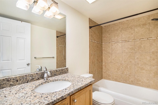 full bathroom featuring vanity, toilet, and tiled shower / bath