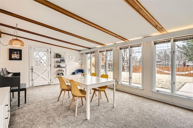 dining space featuring vaulted ceiling with beams and light colored carpet