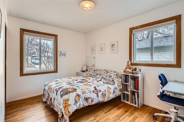 bedroom featuring wood finished floors and baseboards