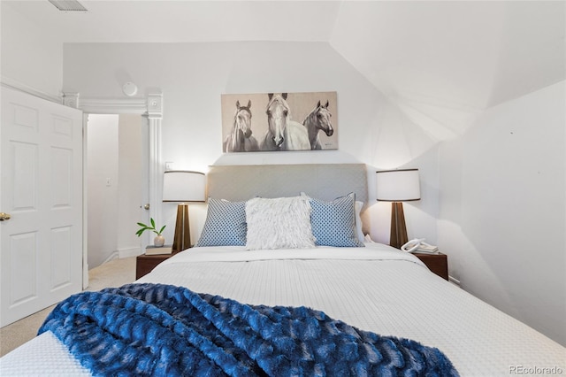 bedroom with carpet and vaulted ceiling