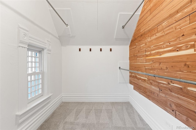 spacious closet with lofted ceiling and light carpet