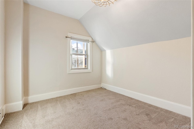 bonus room with vaulted ceiling and carpet floors