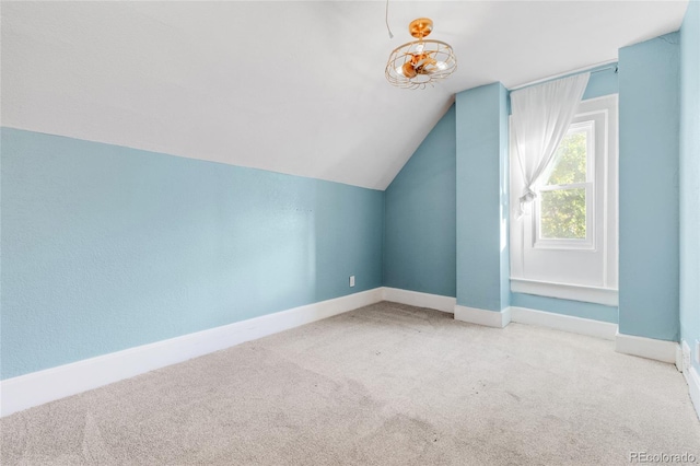 bonus room with light carpet and lofted ceiling