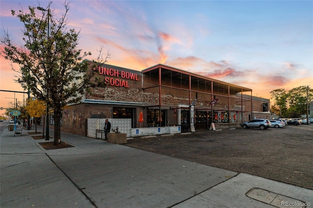 view of outdoor building at dusk