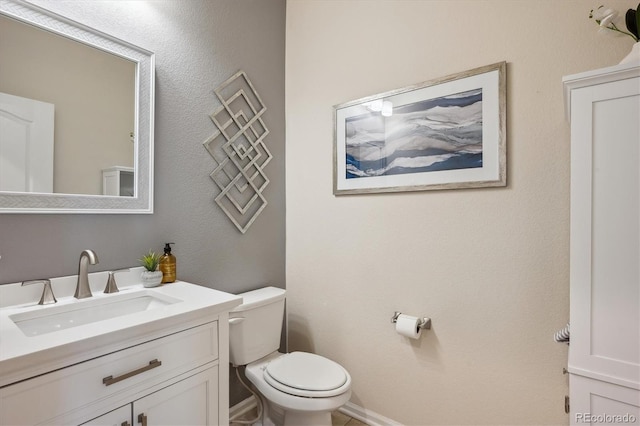 bathroom with toilet and vanity