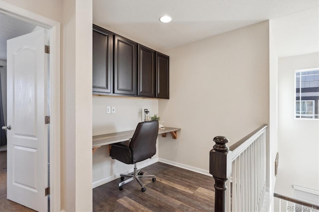 office with dark hardwood / wood-style floors and built in desk