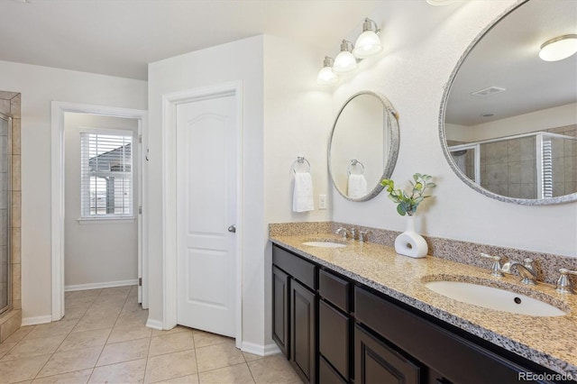 bathroom with tile patterned floors, vanity, and an enclosed shower