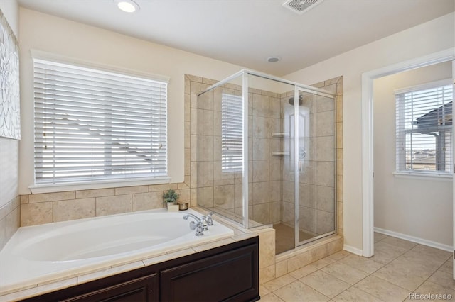 bathroom with independent shower and bath and tile patterned floors