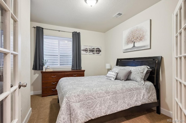 carpeted bedroom with a textured ceiling