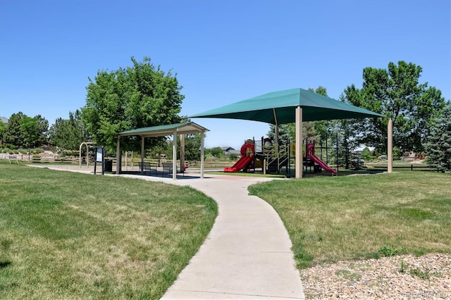 view of home's community featuring a playground and a lawn