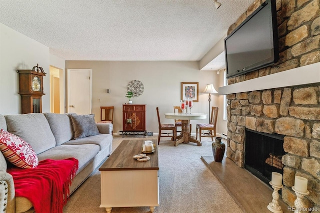 living area with a textured ceiling, carpet, and a fireplace