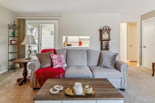 carpeted living room with baseboards and a textured ceiling