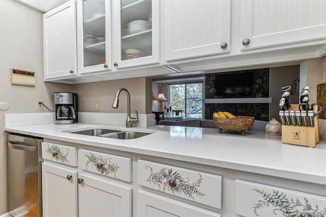 bar with a sink, a stone fireplace, and dishwasher