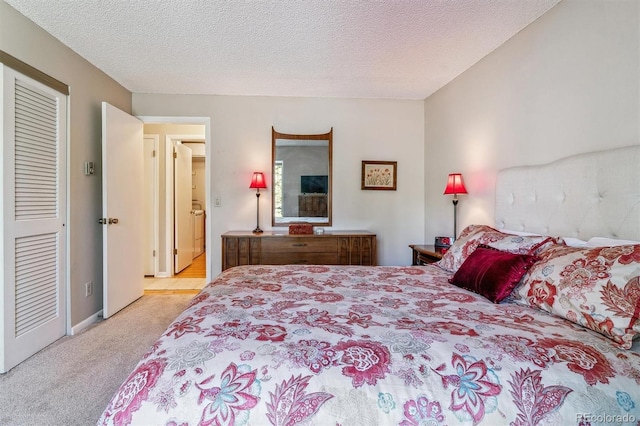 carpeted bedroom featuring a textured ceiling