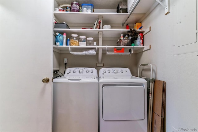 laundry area featuring laundry area, washing machine and dryer, and electric panel