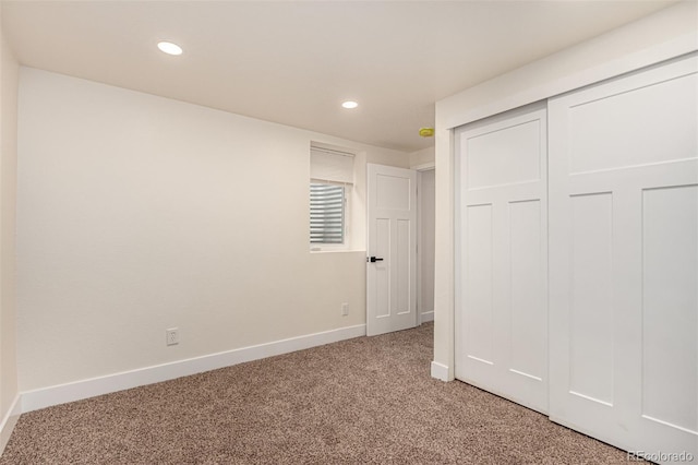 unfurnished bedroom featuring recessed lighting, baseboards, and light colored carpet