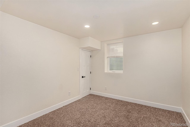 empty room with light carpet, recessed lighting, and baseboards