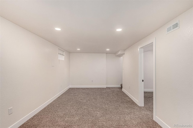 finished basement with visible vents, recessed lighting, carpet, and baseboards