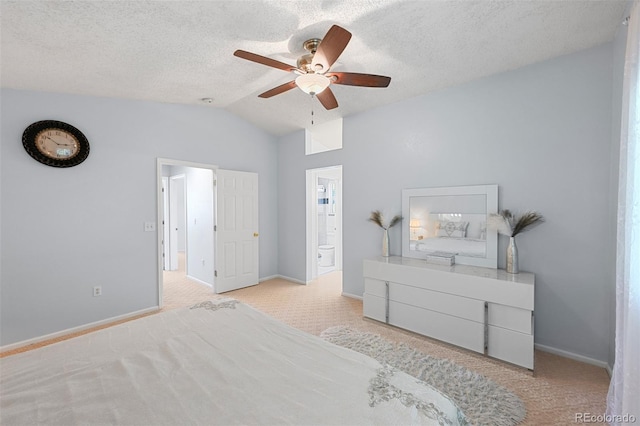 bedroom featuring carpet floors, lofted ceiling, baseboards, ensuite bath, and ceiling fan